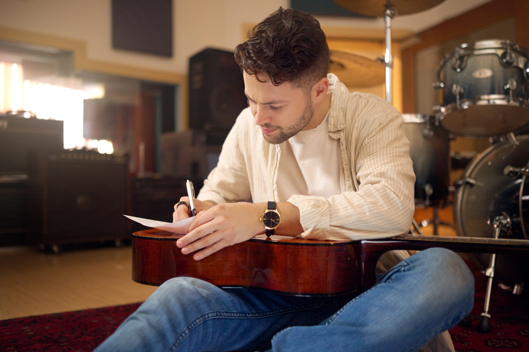 Idea, artist and musician writing a song for a performance, sound and talent in the studio Creative, planning and artist with a guitar for music production, rehearsal and guitarist with a hobby